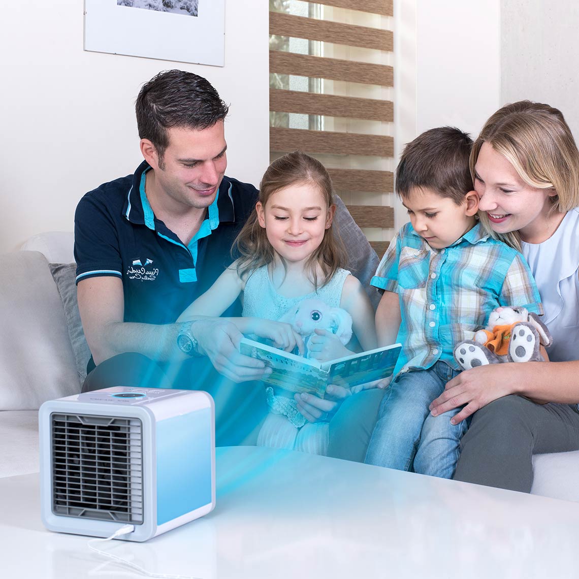 Familie liest gemeinsam auf dem Sofa, vorne steht der Livington Arctic Air für kühle, frische Luft.
