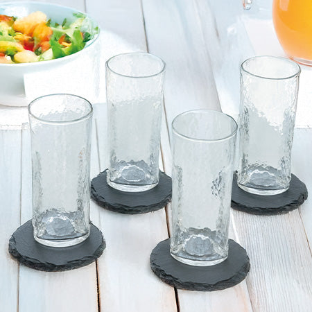 4 Schieferuntersetzer unter Trinkgläsern auf sommerlichem Tisch