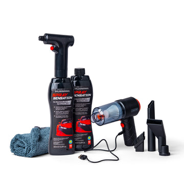 Set zur Autopflege: Zwei Flaschen Platinum SpraySensation, ein Mikrofasertuch und der Livington DustAway Smart Akku-Handstaubsauger mit Zubehör.