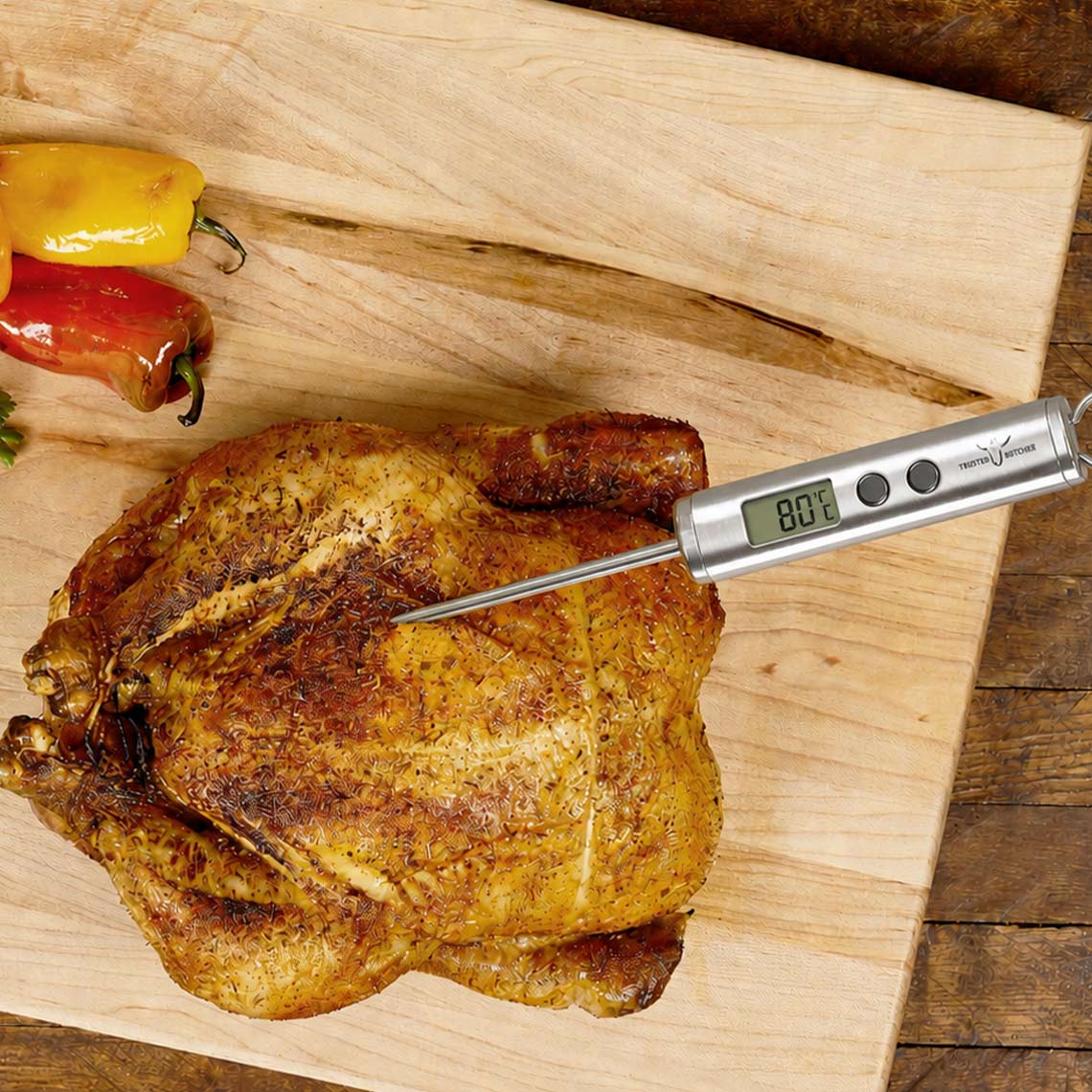 Gebratenes Hähnchen auf Holzbrett mit digitalem Trusted Butcher Fleischthermometer, das eine Kerntemperatur von 80 °C anzeigt
